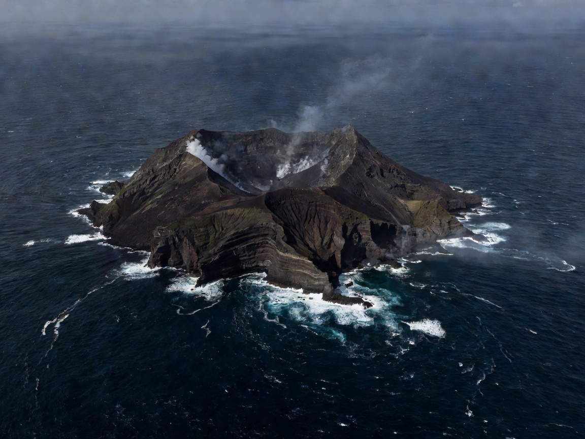 Volcanic crater island of Aogashima surrounded by dark blue Pacific waters
